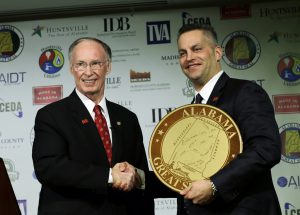 Gov. Robert Bentley presents Remington Outdoor Company Chairman and CEO George Kollitides with an Alabama Great Seal at a jobs announcement in Huntsville, Ala., Monday, Feb. 17, 2014. Remington officials announced they will bring more than 2,000 jobs to Madison County over the next ten years. (Governor's Office, Jamie Martin)