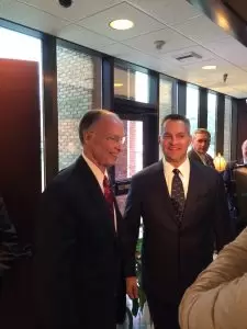 Alabama Gov. Robert Bentley and Remington CEO George Kollitides talk in Huntsville, Feb. 17, 2014, before Remington announced plans to open an Alabama production facility.
